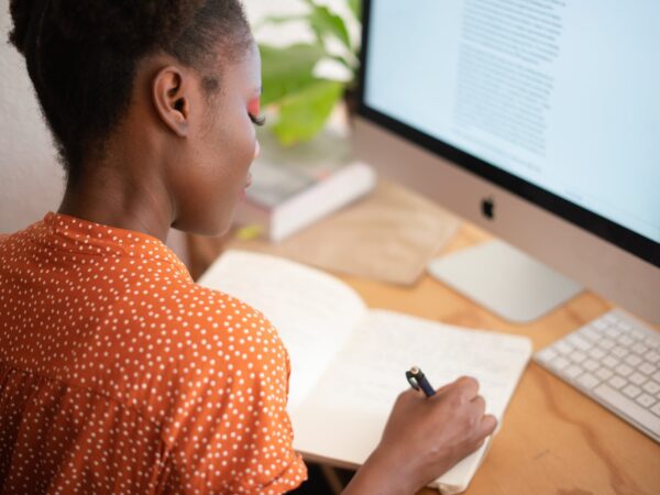 woman writing on her notebook