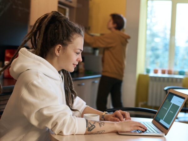 shallow focus photo of woman using a laptop
